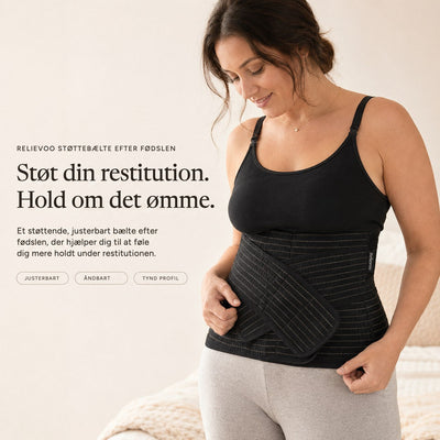 Woman wearing the black Relievoo postpartum support belt over a black vest top, holding the front support strap rvpumpen rvhasar