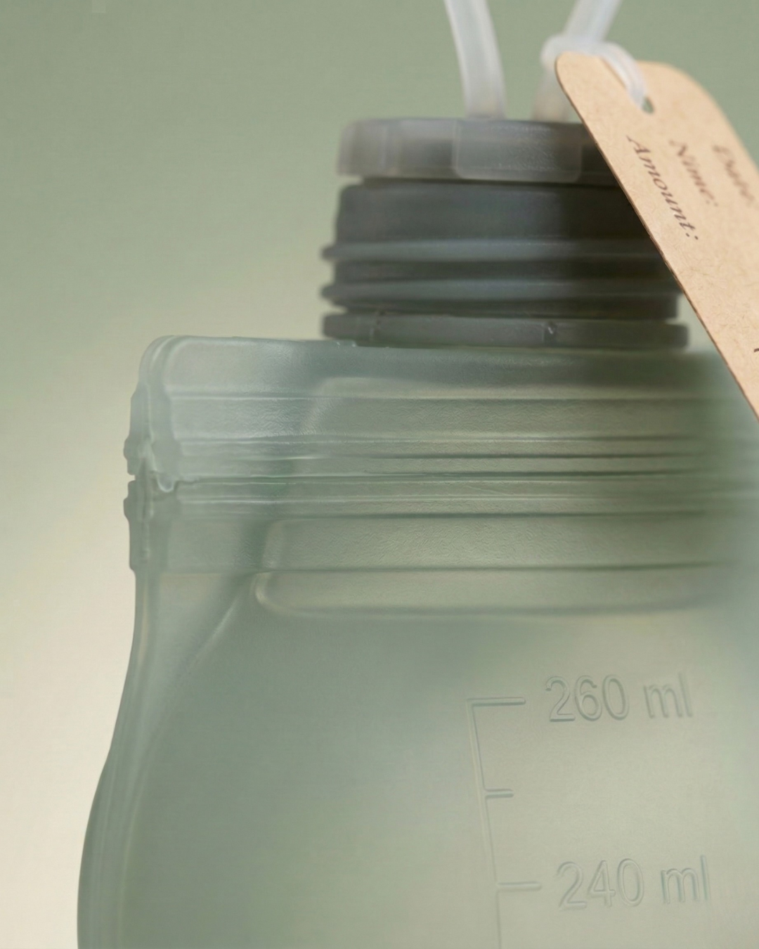 Close-up of Relievoo silicone breast milk storage bag showing leak-proof screw cap and measurement markings
