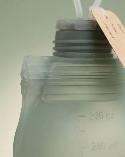 Close-up of Relievoo silicone breast milk storage bag showing leak-proof screw cap and measurement markings