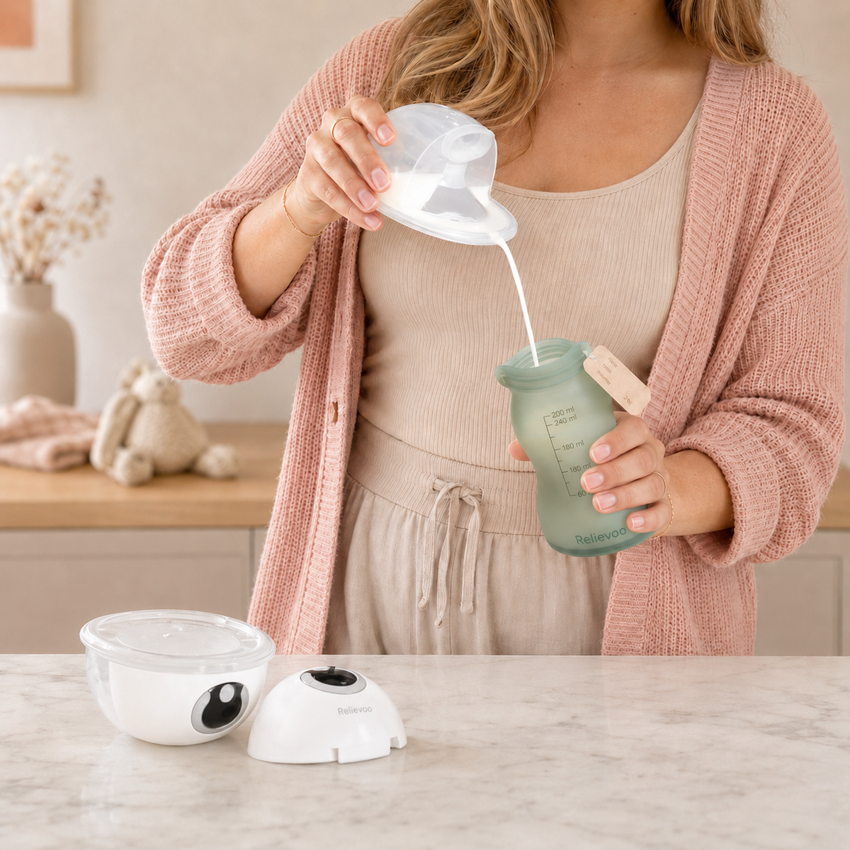 Mother pouring freshly expressed breast milk into a reusable Relievoo silicone breast milk storage bag on a marble kitchen counter