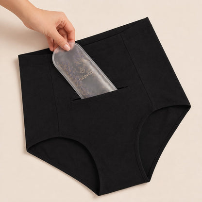 Hand sliding the hot and cold therapy pack into the hidden front pocket of the postpartum brief