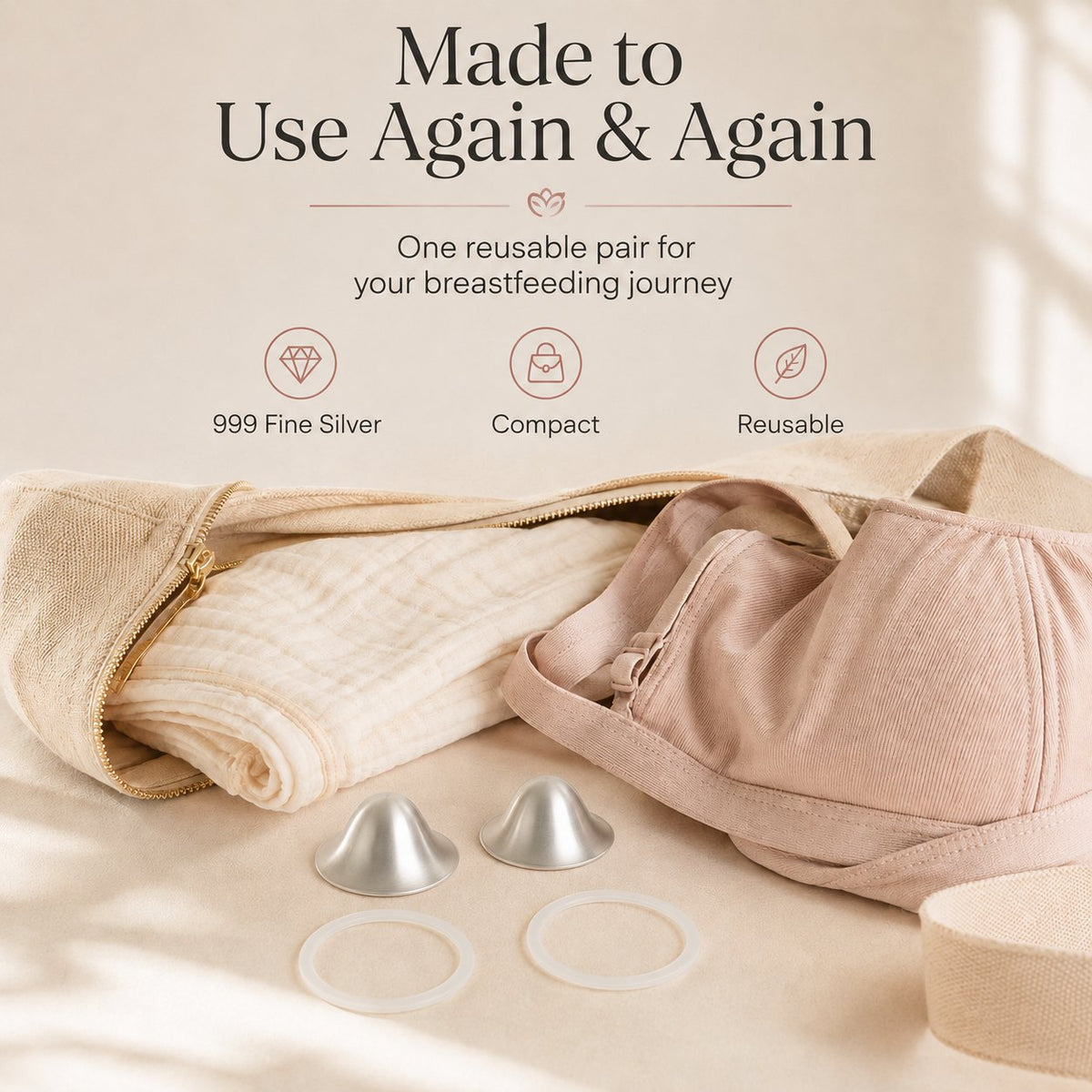One reusable pair of silver nursing cups and two rings laid beside a folded muslin and a soft changing bag rvpumpen rvhasar