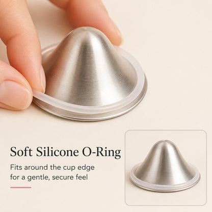 Fingers easing a soft clear silicone o-ring around the outer rim of a silver nursing cup rvpumpen rvhasar