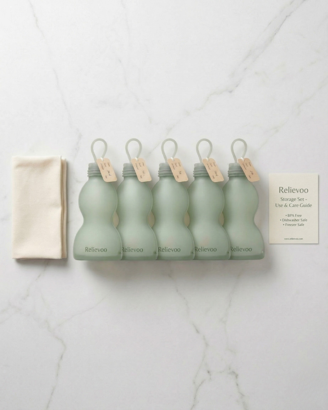 Relievoo reusable silicone breast milk storage bags 5-pack with kraft labels and cotton pouch flat-lay
