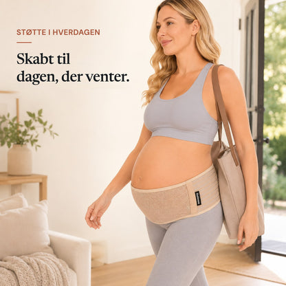 Pregnant woman walking out with a tote bag wearing the tan Relievoo pregnancy support belt rvpumpen rvhasar
