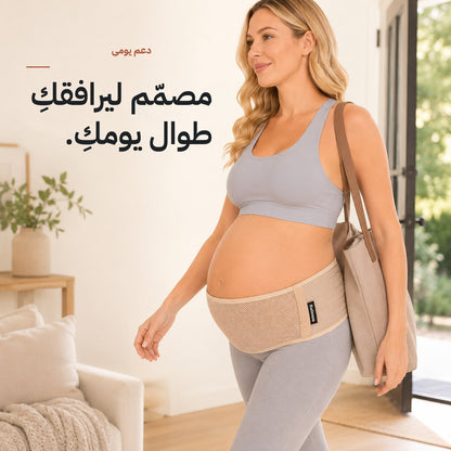 Pregnant woman walking out with a tote bag wearing the tan Relievoo pregnancy support belt