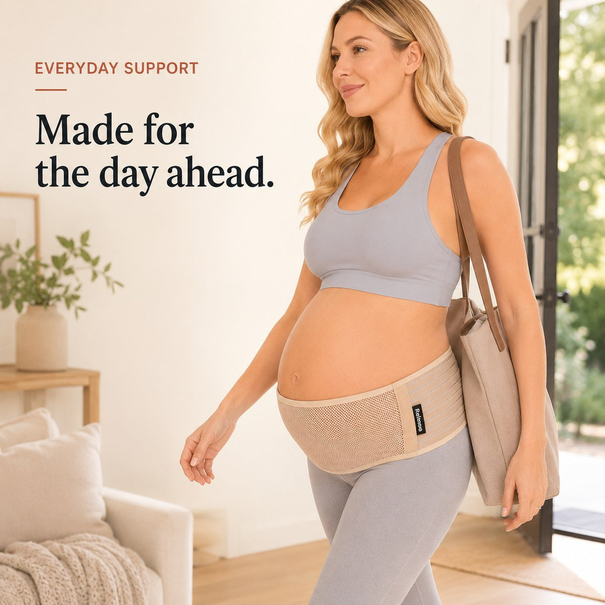 Pregnant woman walking out with a tote bag wearing the tan Relievoo pregnancy support belt rvpumpen rvhasar