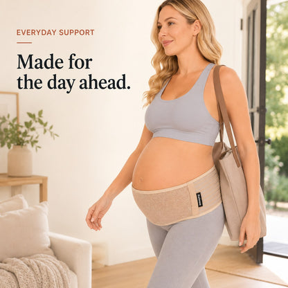 Pregnant woman walking out with a tote bag wearing the tan Relievoo pregnancy support belt rvpumpen rvhasar