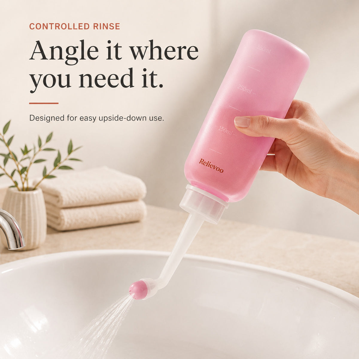 Hand holding the Relievoo peri bottle upside down and rinsing over a basin rvpumpen rvhasar