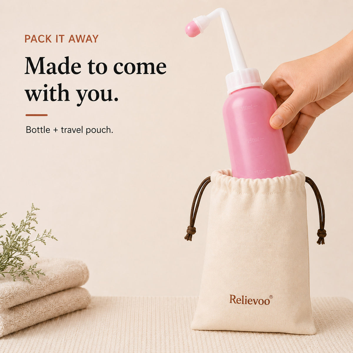 Relievoo peri bottle being placed into its cotton drawstring travel pouch beside folded towels rvpumpen rvhasar
