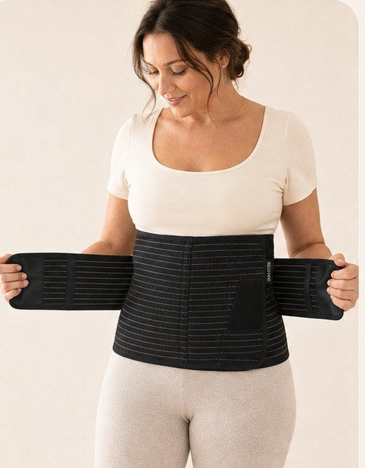 Woman placing the black Relievoo postpartum band around her midsection